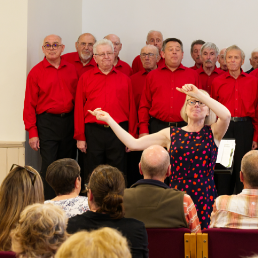 Marion conducting the audience in Sweet Caroline